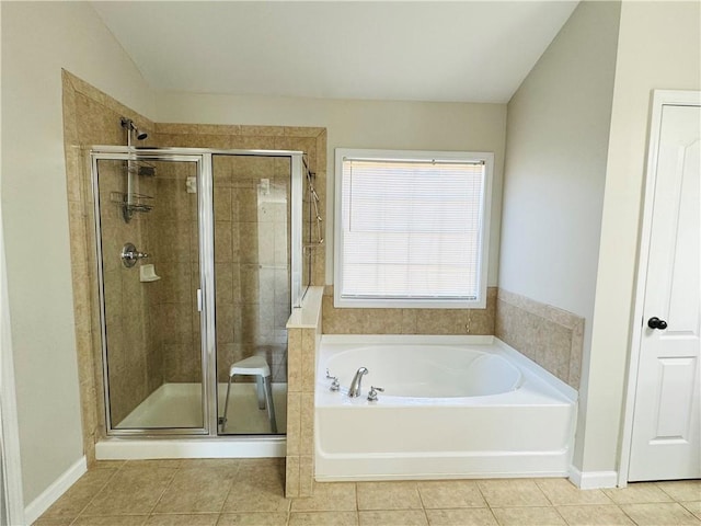 bathroom featuring vaulted ceiling, separate shower and tub, and tile patterned floors