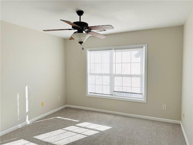 carpeted spare room with ceiling fan