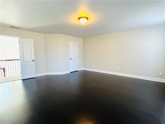 unfurnished room featuring dark hardwood / wood-style floors