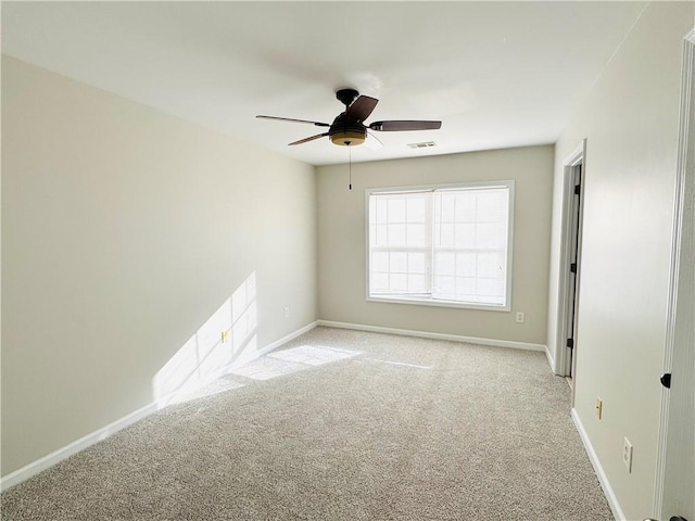 empty room featuring light carpet and ceiling fan