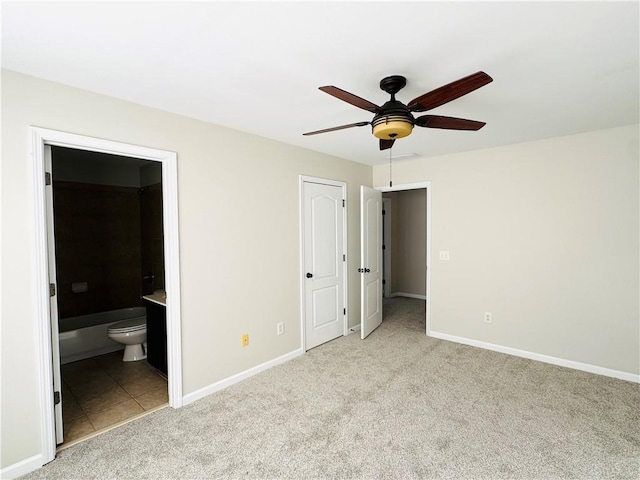 unfurnished bedroom featuring light carpet, ceiling fan, and ensuite bathroom