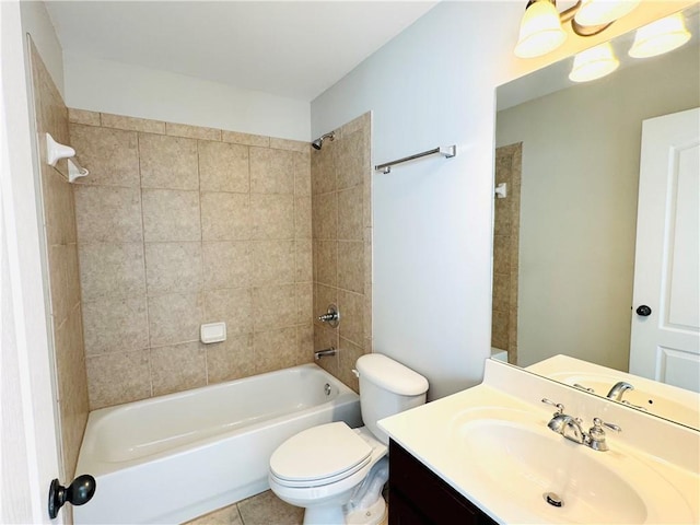 full bathroom featuring tiled shower / bath, vanity, toilet, and tile patterned flooring