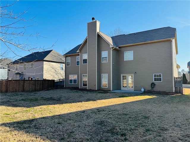 back of property featuring a lawn