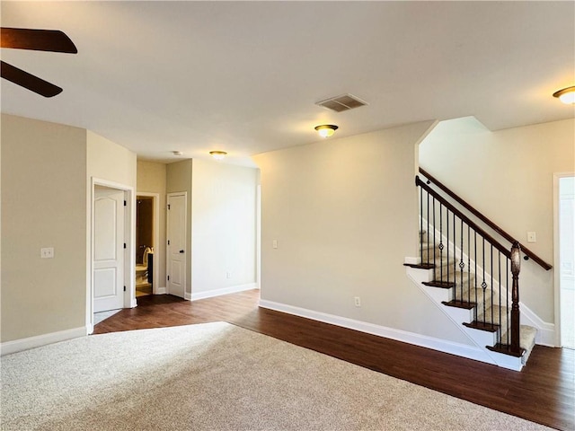 unfurnished room with ceiling fan and dark hardwood / wood-style flooring