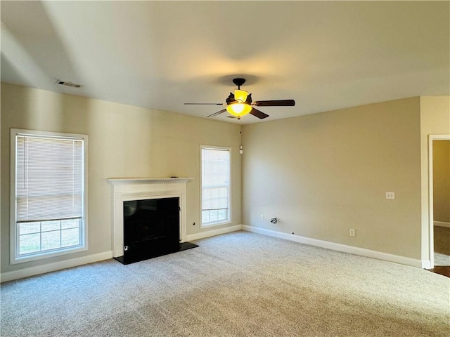 unfurnished living room featuring ceiling fan and light colored carpet