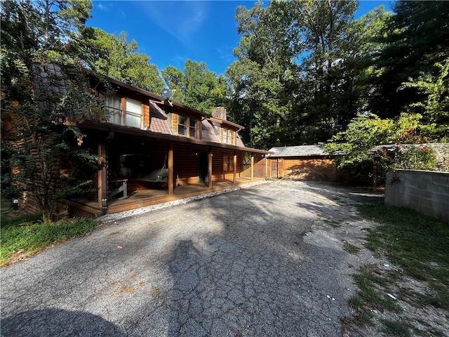 view of property exterior with covered porch