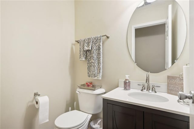 half bathroom featuring vanity and toilet