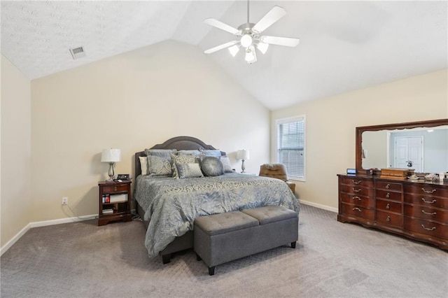 carpeted bedroom with visible vents, a ceiling fan, baseboards, and vaulted ceiling