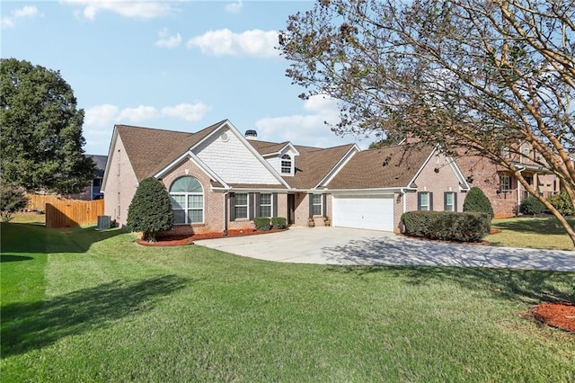 view of front of property featuring brick siding, fence, a front yard, driveway, and an attached garage