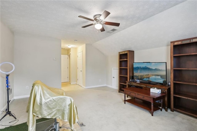 sitting room with visible vents, baseboards, lofted ceiling, carpet floors, and a textured ceiling