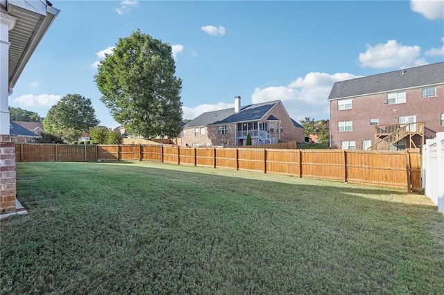 view of yard featuring a residential view and a fenced backyard