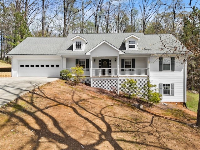 cape cod-style house with an attached garage, roof with shingles, covered porch, and driveway