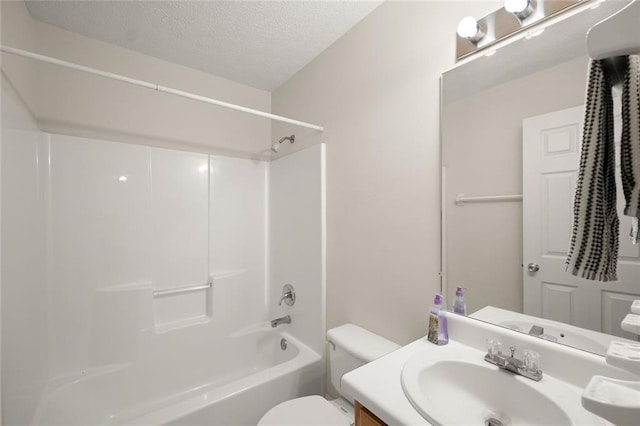 bathroom featuring vanity, a textured ceiling, bathtub / shower combination, and toilet