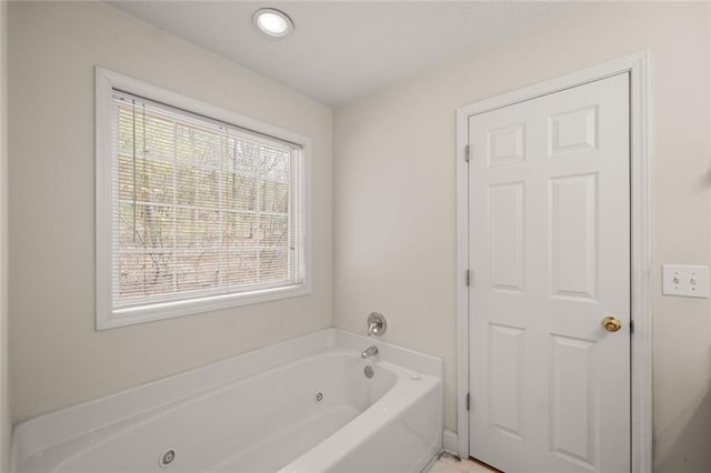 bathroom with a tub with jets