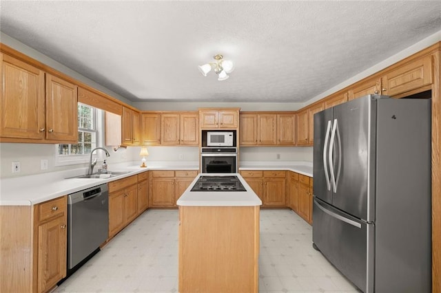kitchen featuring a kitchen island, appliances with stainless steel finishes, a sink, light countertops, and light floors