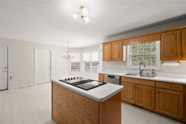 kitchen with black electric stovetop, a sink, light countertops, brown cabinetry, and light floors