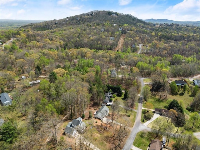 aerial view with a mountain view and a wooded view