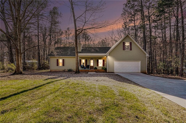 view of front of house featuring a garage, a porch, a lawn, and concrete driveway