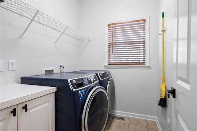 washroom featuring light tile patterned floors, independent washer and dryer, visible vents, and baseboards