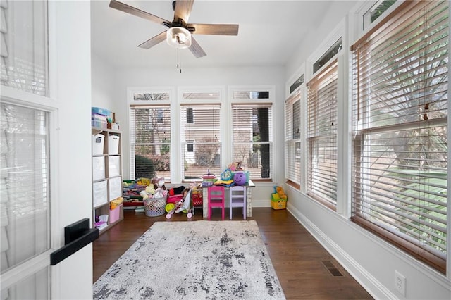 sunroom / solarium featuring visible vents, plenty of natural light, and a ceiling fan