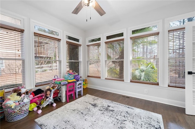 sunroom featuring ceiling fan and a wealth of natural light