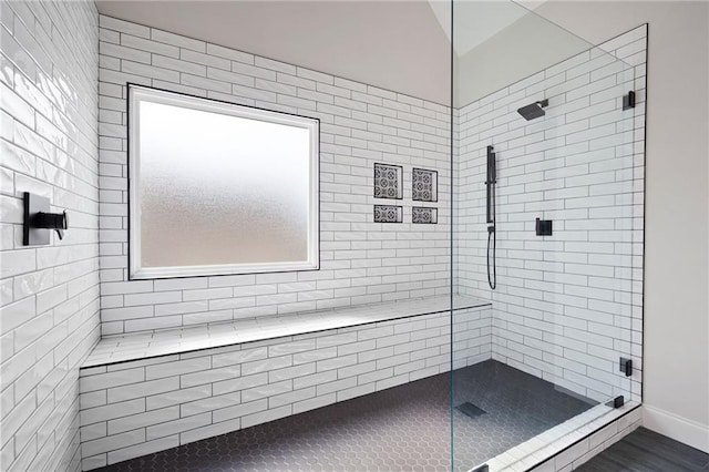 full bathroom with tiled shower and vaulted ceiling