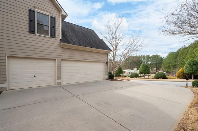 garage with concrete driveway