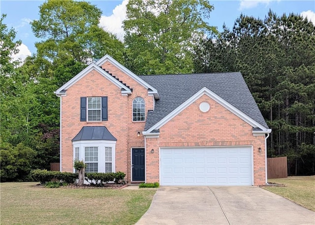 traditional-style home with concrete driveway, an attached garage, brick siding, and roof with shingles