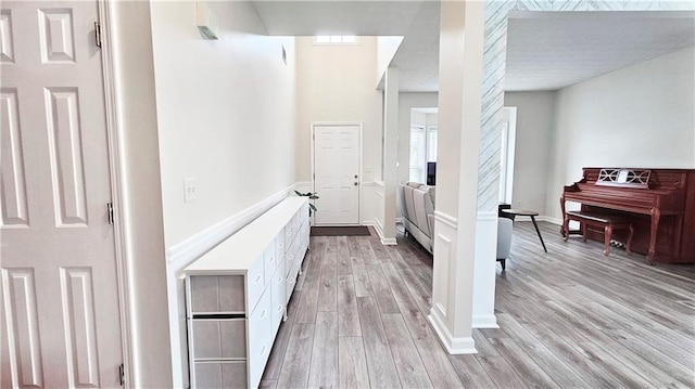 hallway with light wood-style floors and baseboards