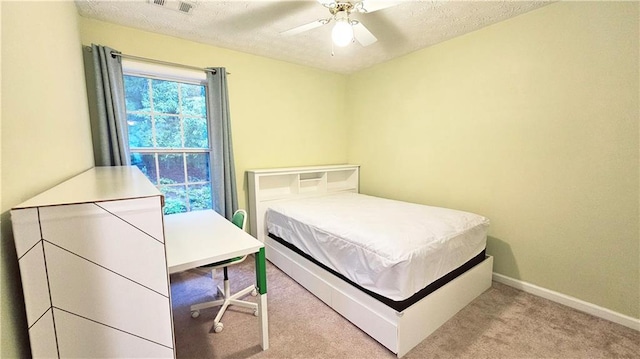 bedroom featuring carpet flooring, a textured ceiling, baseboards, and a ceiling fan