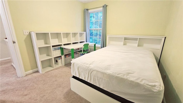 bedroom with carpet flooring and baseboards