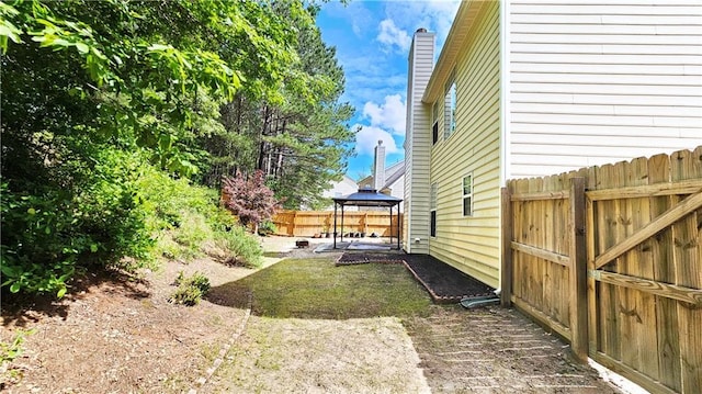 view of yard featuring a gazebo, fence, and a patio area