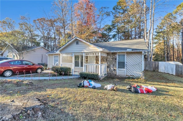 view of front of property with a porch and a front lawn