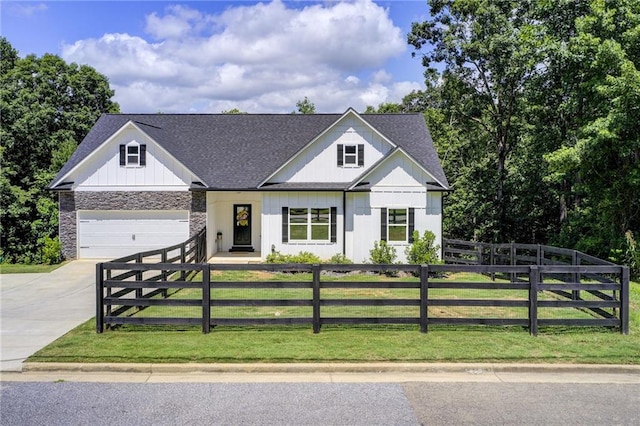 271 Moorings Run, Jasper, GA 30143 - modern inspired farmhouse featuring a fenced front yard, concrete driveway, roof with shingles, stone siding, and an attached garage