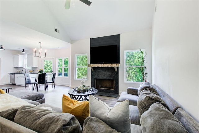 271 Moorings Run, Jasper, GA 30143 - living area with a chandelier, light wood finished floors, a ceiling fan, a fireplace, and high vaulted ceiling