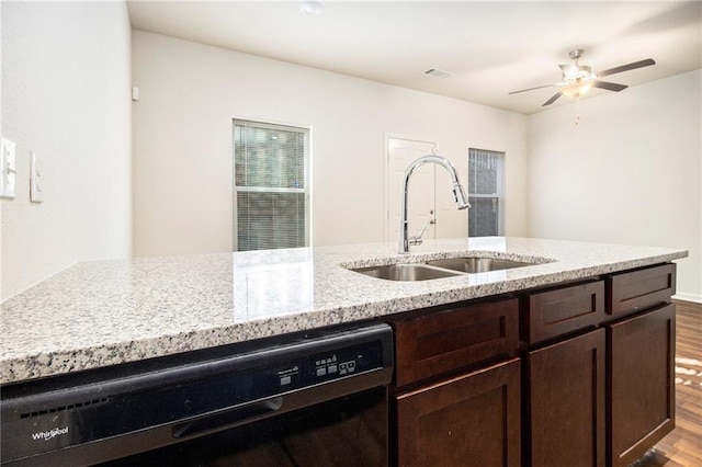 kitchen featuring light stone countertops, dishwasher, sink, ceiling fan, and light hardwood / wood-style flooring