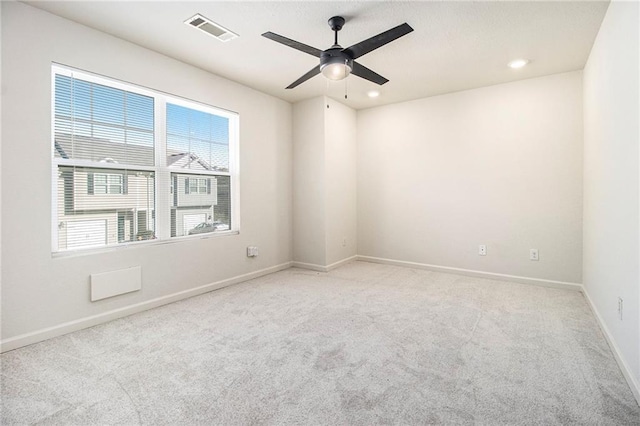 carpeted spare room with ceiling fan