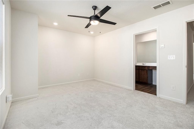 spare room featuring ceiling fan and carpet