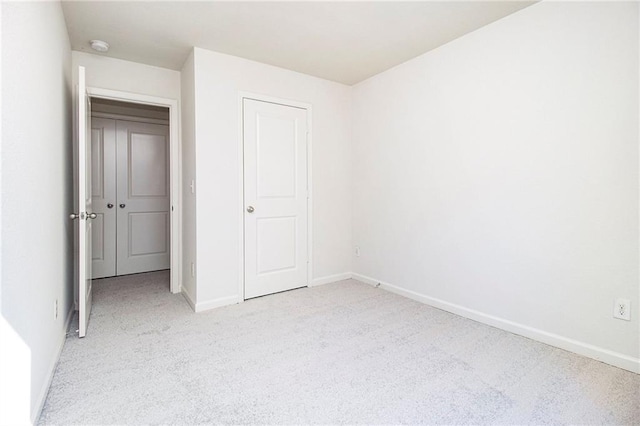 unfurnished bedroom with light carpet