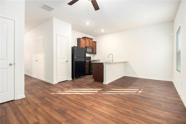 kitchen with black appliances, ceiling fan, dark hardwood / wood-style floors, and sink