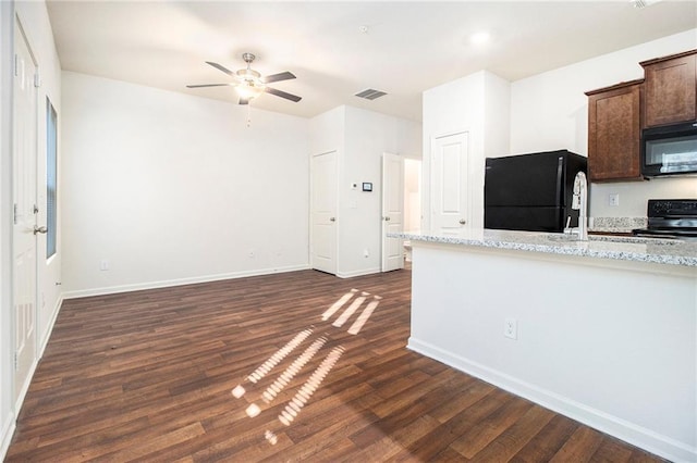 kitchen featuring black appliances, ceiling fan, dark wood-type flooring, and light stone counters