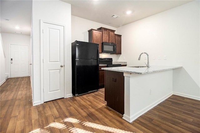 kitchen featuring black appliances, kitchen peninsula, sink, dark hardwood / wood-style flooring, and light stone counters