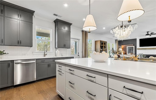 363 Aidens Blf, Jefferson, GA 30549 - kitchen featuring stainless steel dishwasher, crown molding, a sink, open floor plan, and light countertops