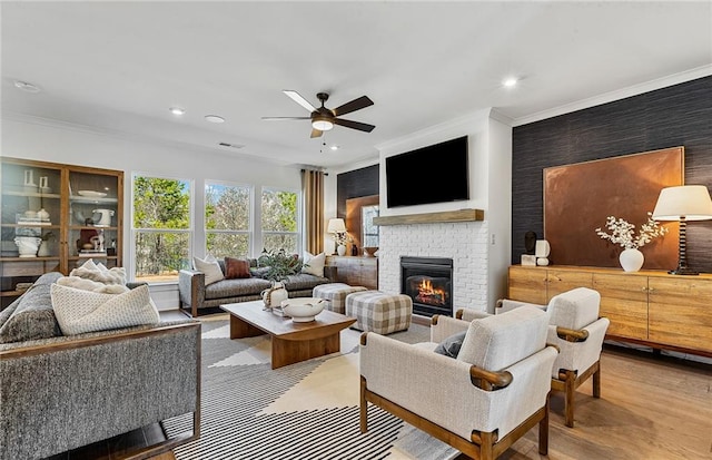 363 Aidens Blf, Jefferson, GA 30549 - living room featuring crown molding, ceiling fan, a brick fireplace, wood finished floors, and recessed lighting