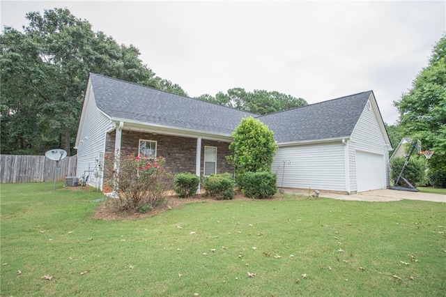 ranch-style home featuring a front yard, fence, and roof with shingles