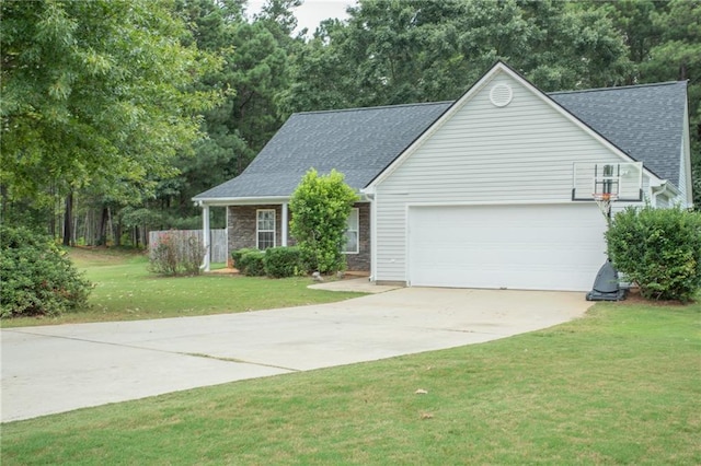 view of front of home with a garage, concrete driveway, a front yard, and roof with shingles