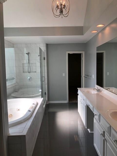 bathroom featuring vanity, a chandelier, shower with separate bathtub, and tile patterned flooring