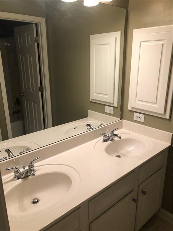 bathroom with tile patterned floors and vanity