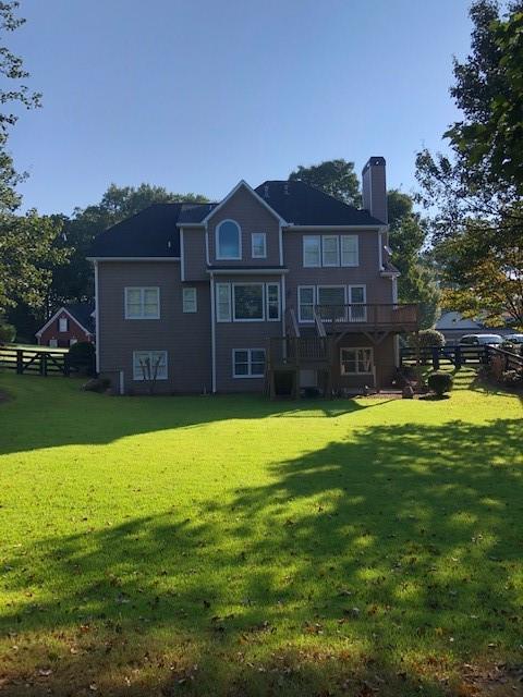 back of house featuring a lawn