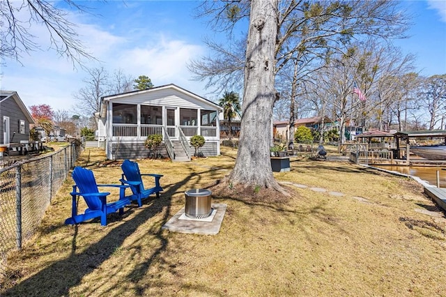 view of yard featuring fence and a sunroom